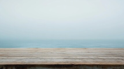 Serene Wooden Table Overlooking Tranquil Blue Ocean in Soft Misty Background