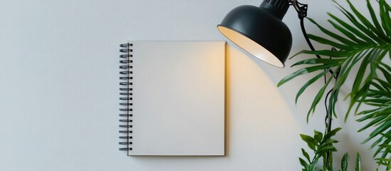 Stylish workspace inspiration with a modern lamp and notepad creating a minimalist flat lay composition for creative environments