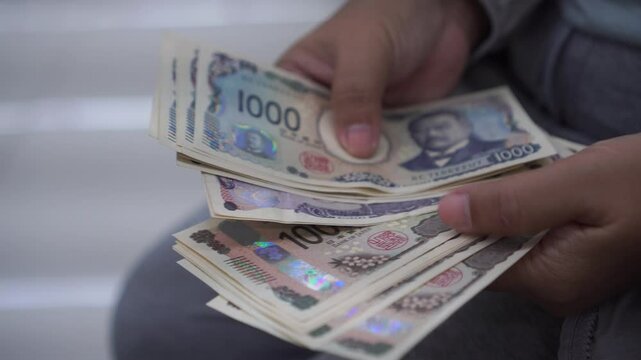 Counting JPY money Japanese Yen banknote in Business people hands for paying shopping goods services, Cash Tax, salary or payment saving cash for economy