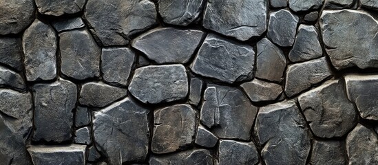 Fototapeta premium Intricate dark gray stone texture ideal for backgrounds and creative design projects showcasing natural elements and depth.