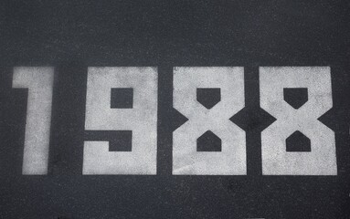 Black granite slab with white numbers 1988 on it