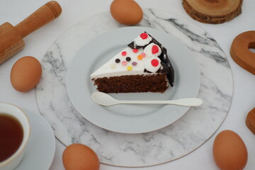 A piece of cake on a plate with white background