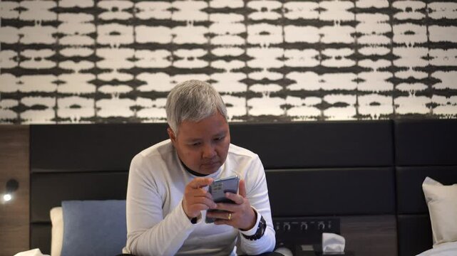 Hands holding smartphone pressing fingerers, reading social media internet, typing shopping online at home