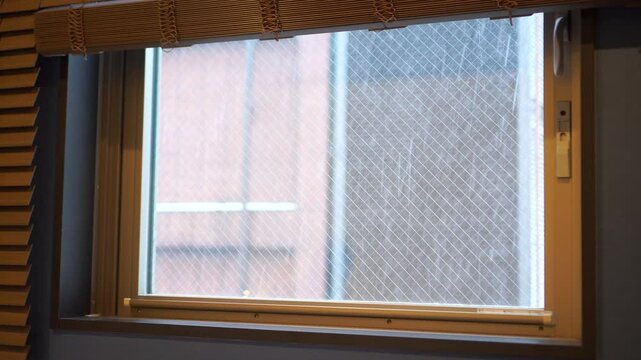 Snow is falling. Looking through window of condo Winter in Sapporo, Hokkaido. Destination for travelers around the world