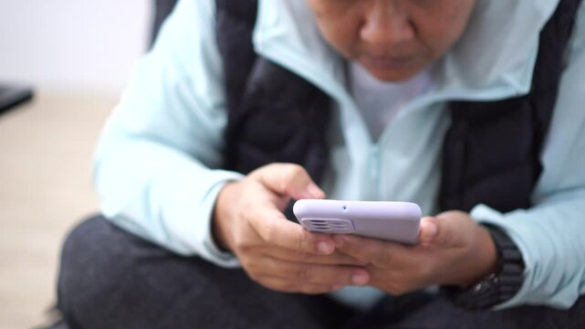 ASEAN tourists Using smartphone check flight schedule information while waiting to check in at airport terminal for travel relax on holiday and Touching gadget choose app