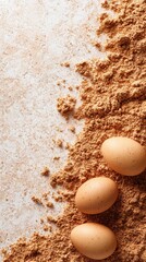Three brown eggs sitting on top of a pile of brown powder