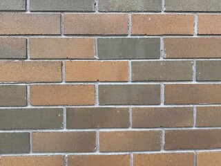 Close up of brick wall. The bricks are brownish in colour