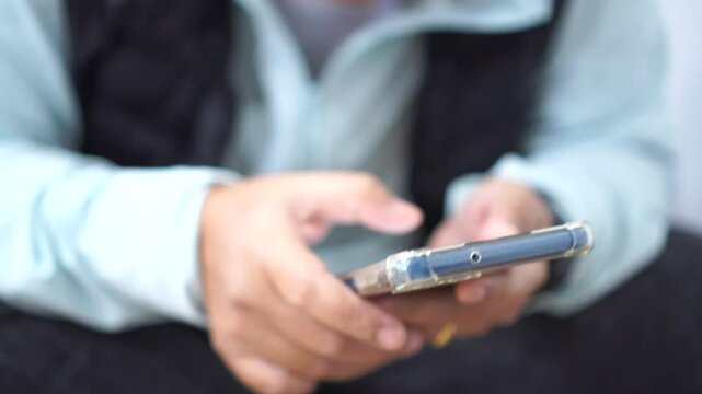 Touching gadget choose app. Tourists Using smartphone check flight schedule information while waiting to check in at airport terminal for travel relax