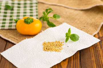 yellow pepper seeds on wooden table
