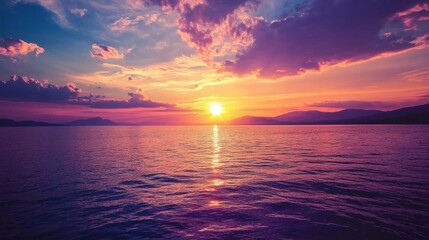 Obraz premium A serene sunset over calm waters, reflecting vibrant colors in the sky.