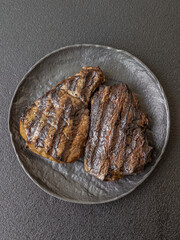 Grilled beef steak with salt, spices and herbs