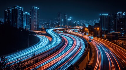 Obraz premium Nighttime cityscape with illuminated traffic trails and skyscrapers.