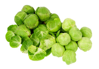 Fototapeta premium Group of Brussels sprouts being peeled and prepared for cooking with peeled and unpeeled sprouts isolated on a white background