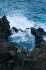 View of Charco De La Laja, a natural volcanic pool located along the rugged coast of Tenerife, Canary Islands. Crystal-clear pool, waves crashing against. hidden gem offers a serene retreat for swim
