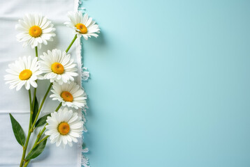 Three white daisies with yellow centers on a light blue background.