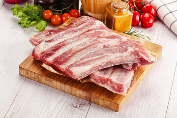 Raw pork ribs over board