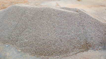 Pile of gravel at a construction site during daylight hours ready for use in various building projects