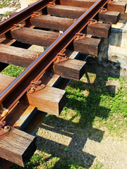 Fototapeta premium Close-up of a railway with its shadow on a ground on a sunny day. 