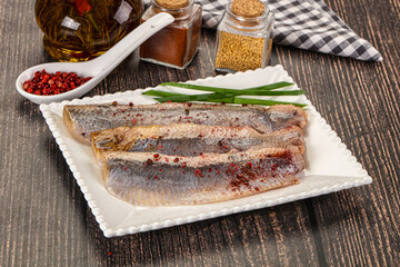 Salted marinated herring fillet with spices