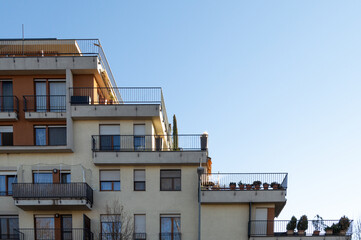 apartment building with rooftop terraces and balconies
