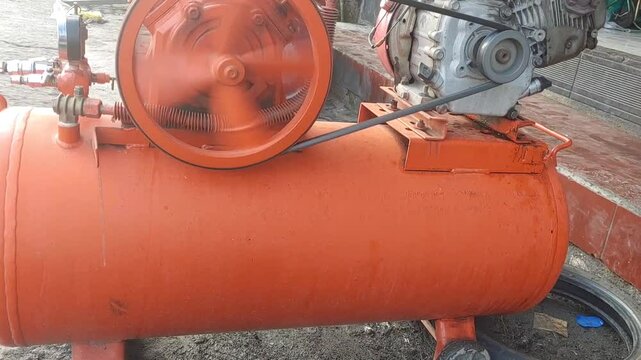 piston air compressor used in an auto shop for inflating car or motorcycle tires.