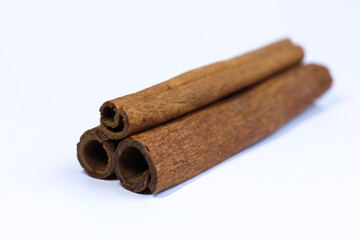 Cinnamon sticks isolated on white background. Selective focus and shallow depth of field.