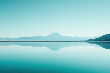 Photograph of Mount Fuji in Japan with a clear blue sky and a calm lake, the reflection on the water surface creating a geometric abstract design.