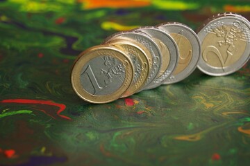 1 Euro and 2 Euro coins standing on the edge. Eurozone currency.