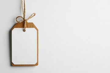 Hanging retail tag with soft cotton string minimalist design studio setting close-up view product branding concept