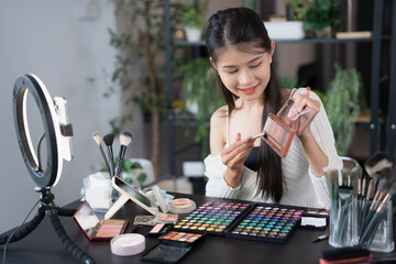 beauty blogger Young Asian girl makeup artist Professional Woman blogger vlogger is showing cosmetics products with recording video Beauty influencer asian girl video online marketing live streaming
