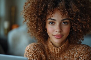 Executive Woman with Curly Hair Smiling while Working on Laptop in Minimalist Office Environment