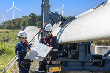 Inspection engineers a rotor blade of a wind turbine. Professional Man Maintenance engineers...