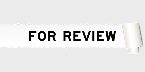 Ripped gray paper background that have word for review under torn part