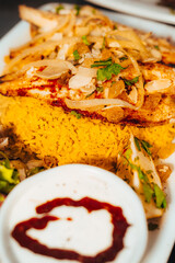 Grilled Fish Over Saffron Rice with Onions and Almond Garnish Close-Up