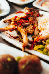 Grilled Quail with Pomegranate Garnish and Rice Close-Up Shot