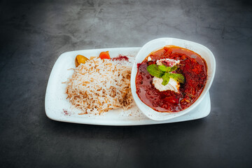 Lamb Stew with Rice and Garnishes on a Plate