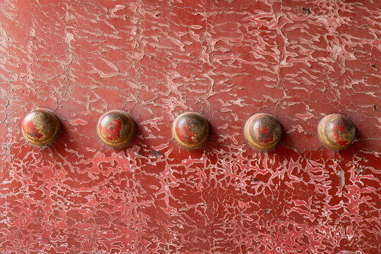 A doornail on a wooden door of the Forbidden City in Beijing, China