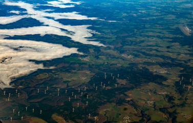 Aerial view of wind turbines and landscape with fog in Germany