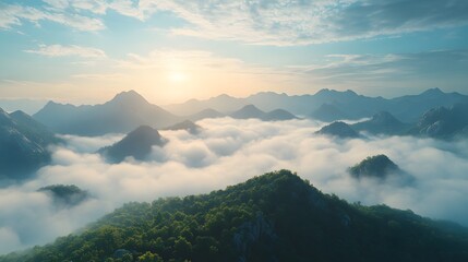 Aerial view of misty mountains with rolling fog, morning sunlight, and blue sky, creating an ethereal, dreamy landscape with cinematic lighting.