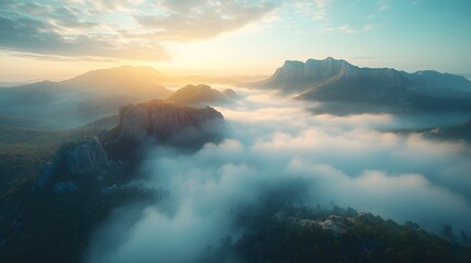 Aerial view of misty mountains with rolling fog, morning sunlight, and blue sky, creating an ethereal, dreamy landscape with cinematic lighting.