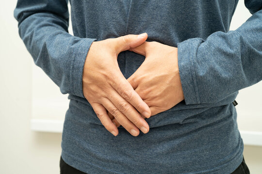 Hernia, Asian man stomach ache, abdominal pain and urology problem health.