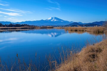 A beautiful photograph of Mount Fuji with its reflection on the lake, a blue sky, and a minimalist style. The image is high resolution, high quality, and high in detail, with a sharp focus and no blur