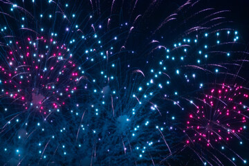 A dazzling display of golden fireworks streaking across the night sky, accented by vibrant red...