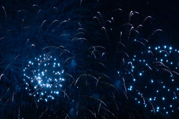 A dazzling display of golden fireworks streaking across the night sky, accented by vibrant red...