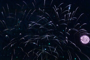 A dazzling display of golden fireworks streaking across the night sky, accented by vibrant red...