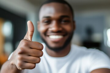Smiling Man Giving Thumbs Up in Bright Office Setting