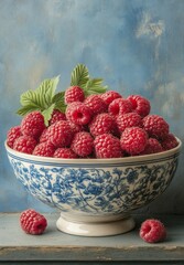 Fresh raspberries in a decorative bowl with floral design on a rustic background