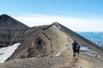 Fototapeta premium tourists walk through the beautiful landscapes of Kamchatka on a volcano