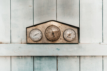 Vintage barometer on a wooden background.