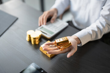 Gold Trading business man hand offering gold Investment in gold mining company or Trading gold on...